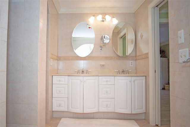 bathroom featuring tile patterned floors, crown molding, vanity, and tile walls