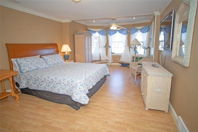 bedroom with ceiling fan, ornamental molding, and light hardwood / wood-style flooring