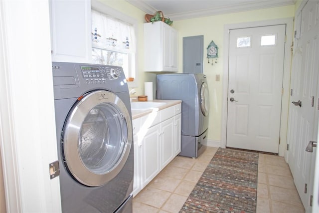 laundry room featuring cabinets, separate washer and dryer, plenty of natural light, and ornamental molding