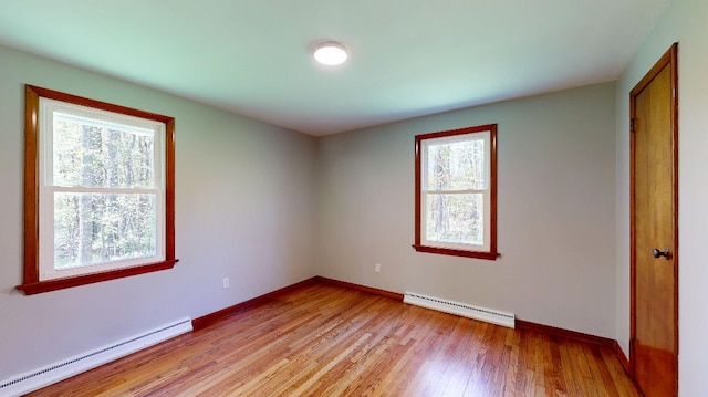 9170 Storey Rd, North East, PA 16428 - unfurnished bedroom with a baseboard heating unit, baseboard heating, baseboards, and light wood-style flooring