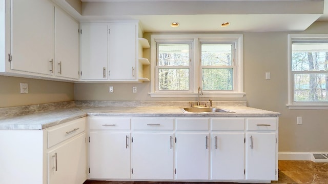 9170 Storey Rd, North East, PA 16428 - kitchen with a sink, white cabinetry, open shelves, light countertops, and baseboards