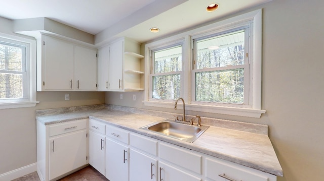 9170 Storey Rd, North East, PA 16428 - kitchen featuring a sink, white cabinetry, light countertops, and open shelves
