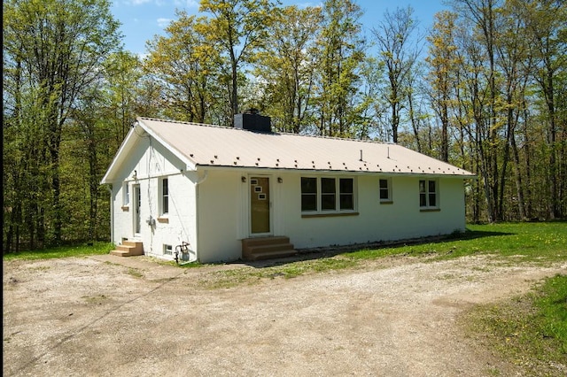 9170 Storey Rd, North East, PA 16428 - view of front of house featuring entry steps, a chimney, and metal roof