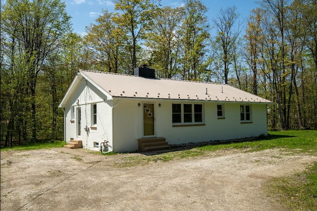 9170 Storey Rd, North East, PA 16428 - view of front facade with entry steps, a chimney, and metal roof