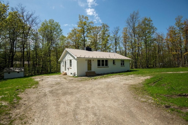 9170 Storey Rd, North East, PA 16428 - view of front facade featuring driveway, an outbuilding, metal roof, entry steps, and a front yard