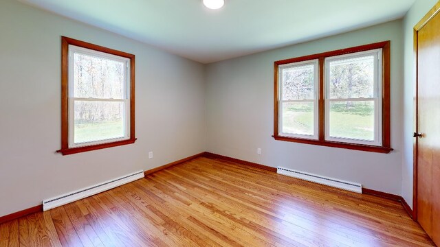 9170 Storey Rd, North East, PA 16428 - unfurnished room featuring a baseboard heating unit, light wood-type flooring, and baseboards