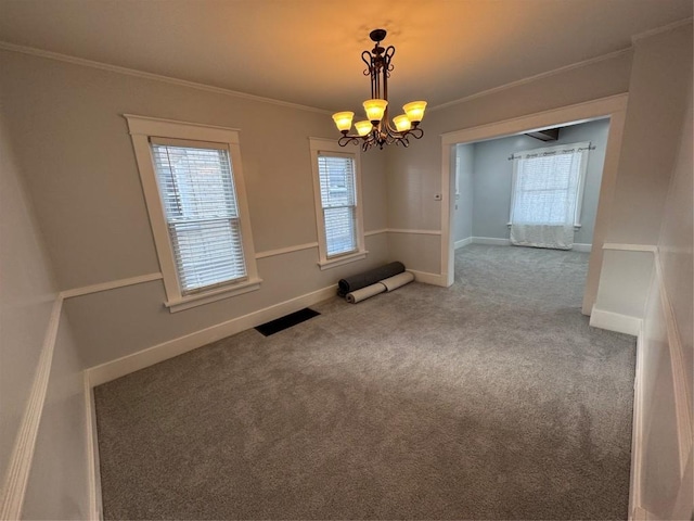 unfurnished dining area with ornamental molding, carpet flooring, and a notable chandelier