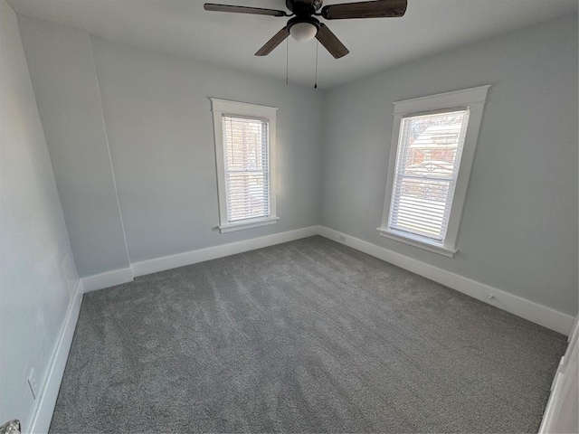 carpeted empty room with ceiling fan and plenty of natural light