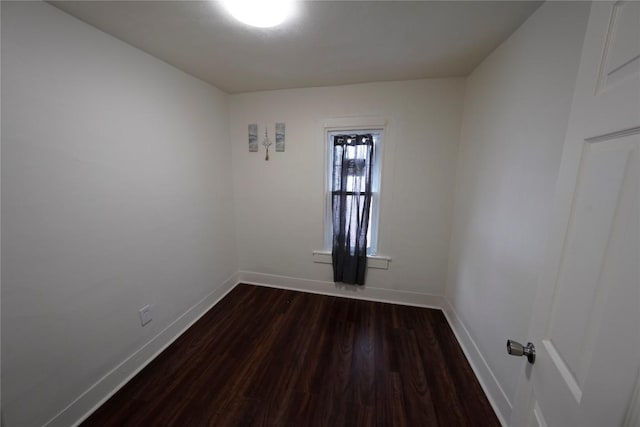 spare room featuring dark hardwood / wood-style flooring and a textured ceiling