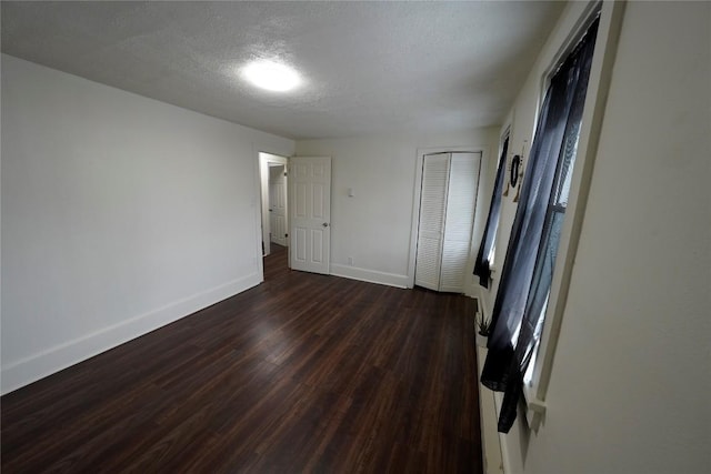 unfurnished room featuring dark hardwood / wood-style flooring and vaulted ceiling