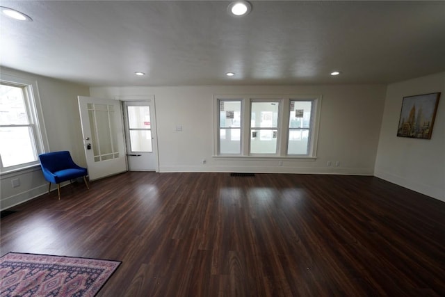 living room featuring dark hardwood / wood-style floors and a brick fireplace