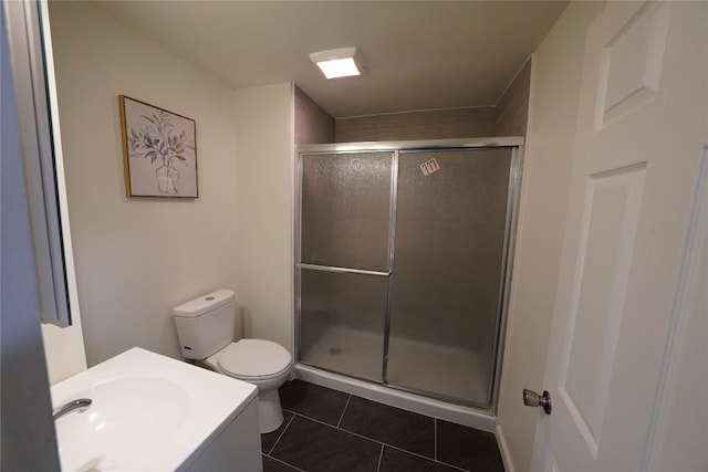 bathroom featuring toilet, vanity, and tile patterned floors