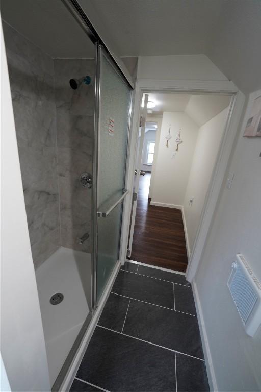 additional living space with lofted ceiling and dark wood-type flooring