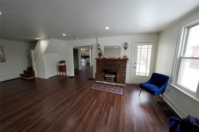 hallway featuring dark hardwood / wood-style flooring and brick wall