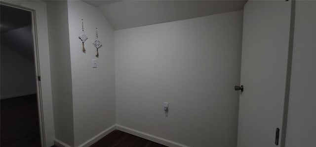 additional living space featuring dark hardwood / wood-style flooring, a textured ceiling, and vaulted ceiling