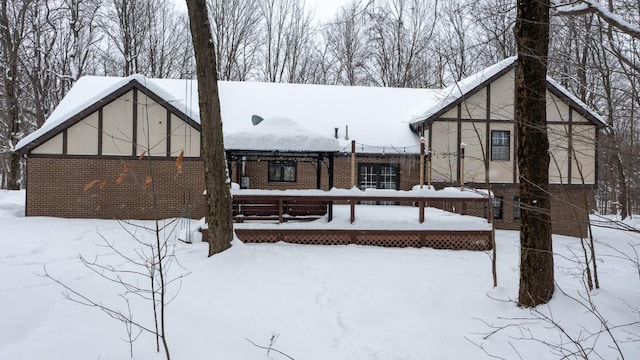 view of snow covered back of property