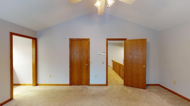 unfurnished bedroom with ceiling fan, light carpet, and vaulted ceiling