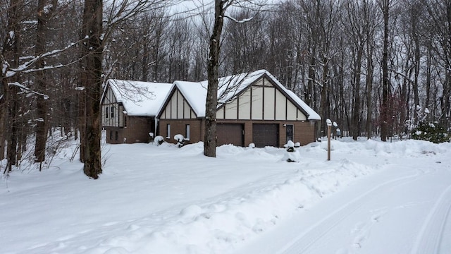 snow covered property featuring a garage