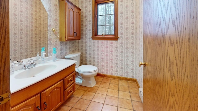 bathroom featuring tile patterned flooring, vanity, and toilet