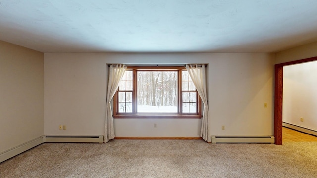 carpeted empty room featuring a baseboard heating unit