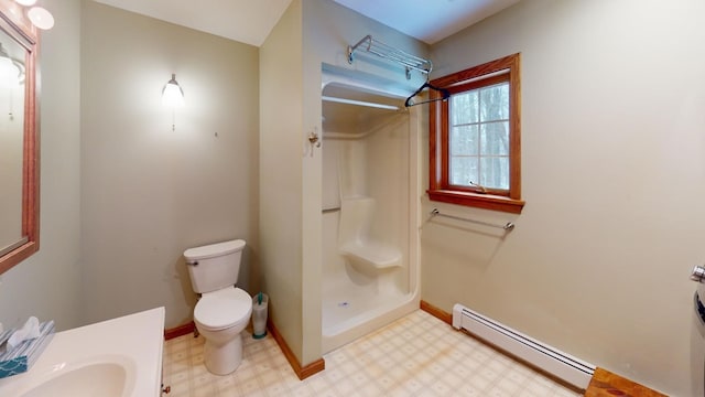 bathroom featuring a shower, a baseboard radiator, toilet, and sink