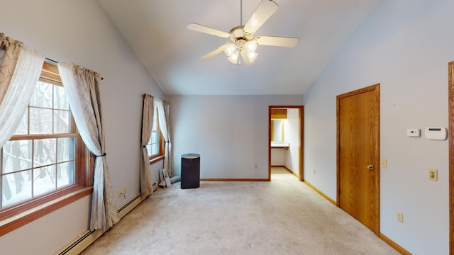 empty room featuring ceiling fan, light carpet, vaulted ceiling, and a baseboard heating unit