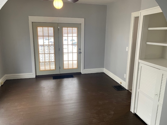 doorway featuring dark hardwood / wood-style floors and built in features