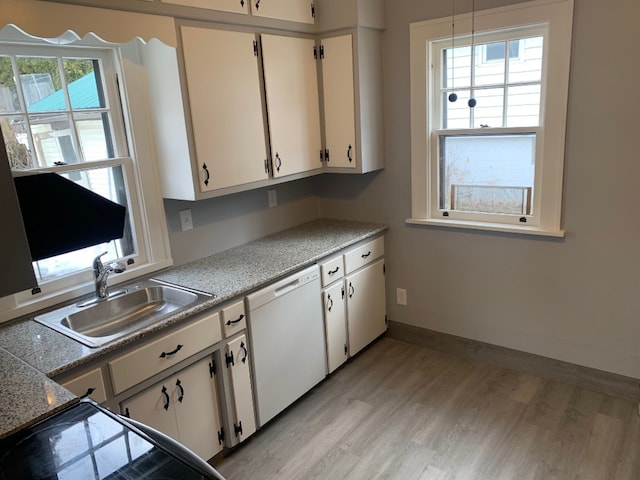 kitchen featuring white cabinets, sink, dishwasher, and light wood-type flooring