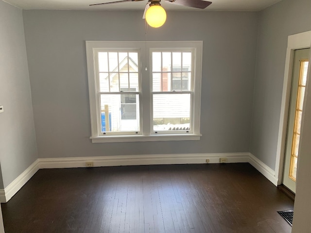 spare room with dark hardwood / wood-style floors and ceiling fan