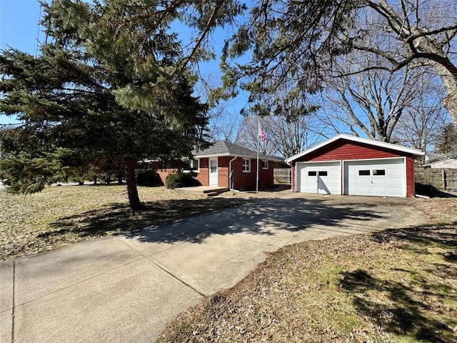 view of front of property with an outbuilding, a garage, and brick siding