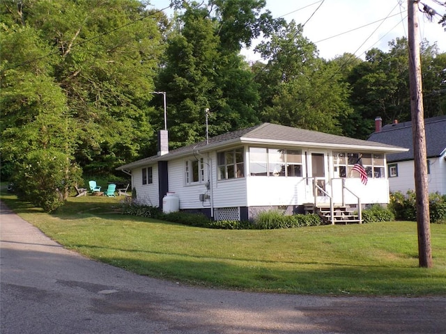 179 Elk Creek Rd, Lake City Boro, PA 16423 - single story home with a chimney, a front lawn, and a sunroom