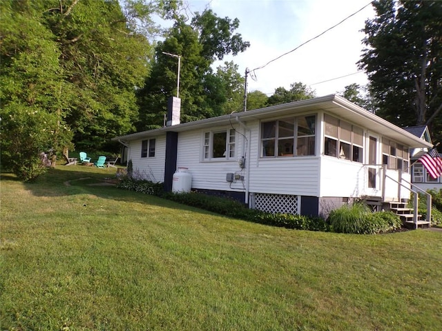 179 Elk Creek Rd, Lake City Boro, PA 16423 - view of home's exterior featuring a chimney and a yard