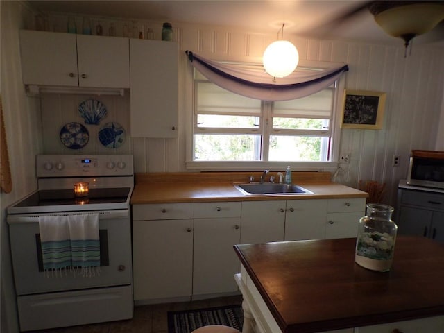 179 Elk Creek Rd, Lake City Boro, PA 16423 - kitchen with white range with electric cooktop, stainless steel microwave, and white cabinets