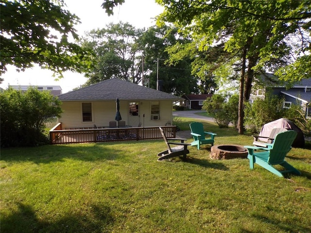 179 Elk Creek Rd, Lake City Boro, PA 16423 - view of grassy yard with an outdoor fire pit and a deck