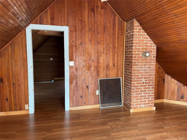 additional living space with hardwood / wood-style flooring, vaulted ceiling, wood ceiling, and wooden walls