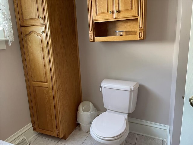 bathroom featuring toilet and tile patterned flooring