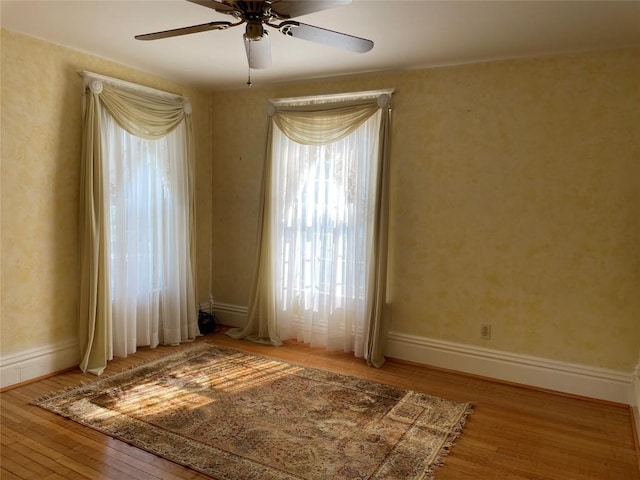 unfurnished room with ceiling fan and light hardwood / wood-style flooring