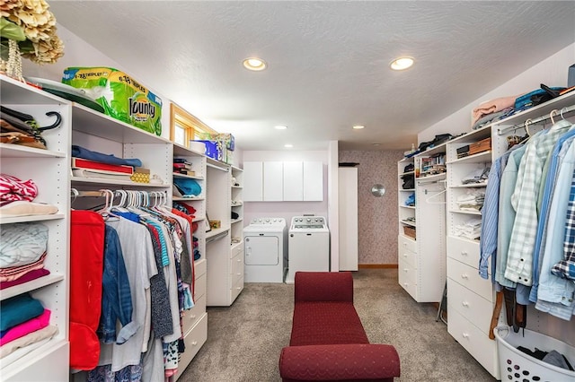 walk in closet with washing machine and dryer and carpet floors