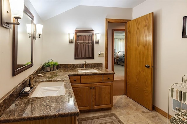 bathroom with heating unit, vanity, and vaulted ceiling