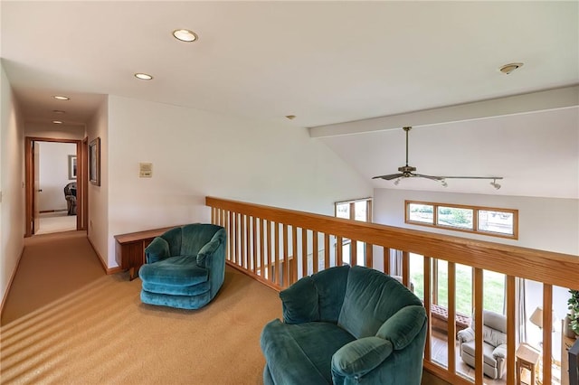 sitting room featuring carpet flooring, lofted ceiling with beams, and ceiling fan