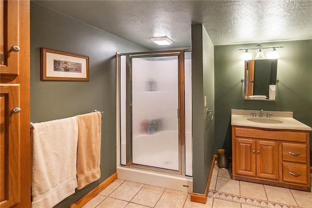 bathroom with tile patterned floors, an enclosed shower, and a textured ceiling