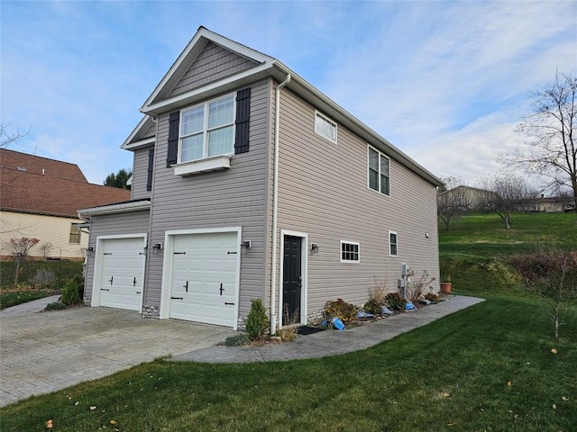 rear view of house with a garage and a lawn