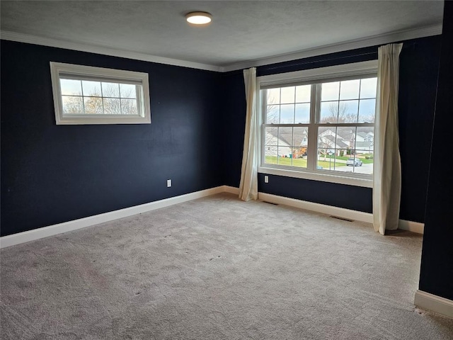 carpeted empty room featuring ornamental molding