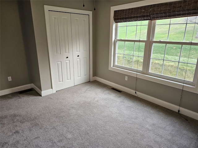 unfurnished bedroom with a closet and carpet