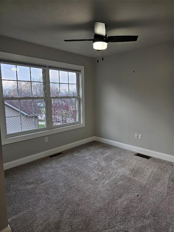 spare room featuring carpet flooring and ceiling fan