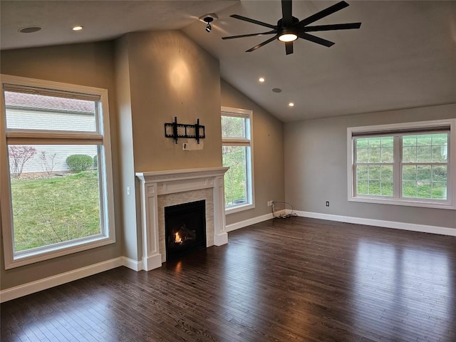 unfurnished living room with plenty of natural light, dark hardwood / wood-style flooring, and lofted ceiling