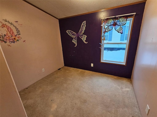 unfurnished room with a textured ceiling, carpet floors, and crown molding