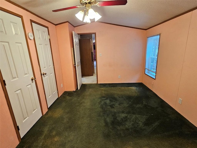 carpeted empty room featuring ceiling fan, ornamental molding, and a textured ceiling