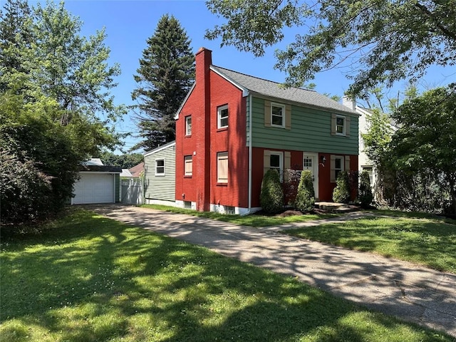 3010 Oakwood St, Erie, PA 16508 - colonial-style house featuring a chimney, a front lawn, an outdoor structure, and a garage