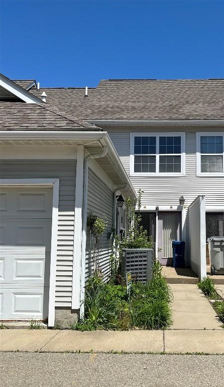 234 Walnut St Unit 13, Meadville, PA 16335 - view of property exterior with central AC and a garage